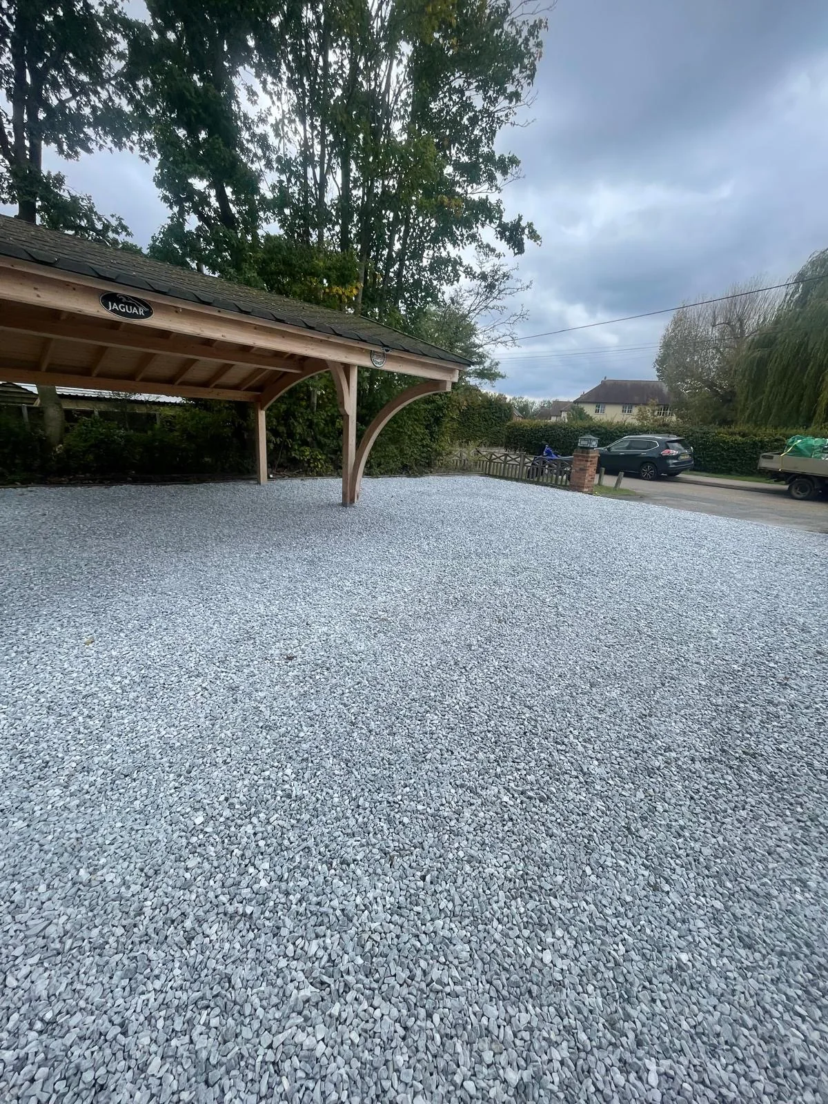 Gravelled front access area with timber shelter