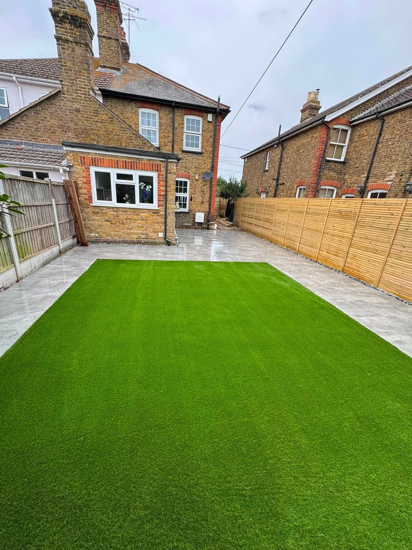 Artificial lawn with paved surround