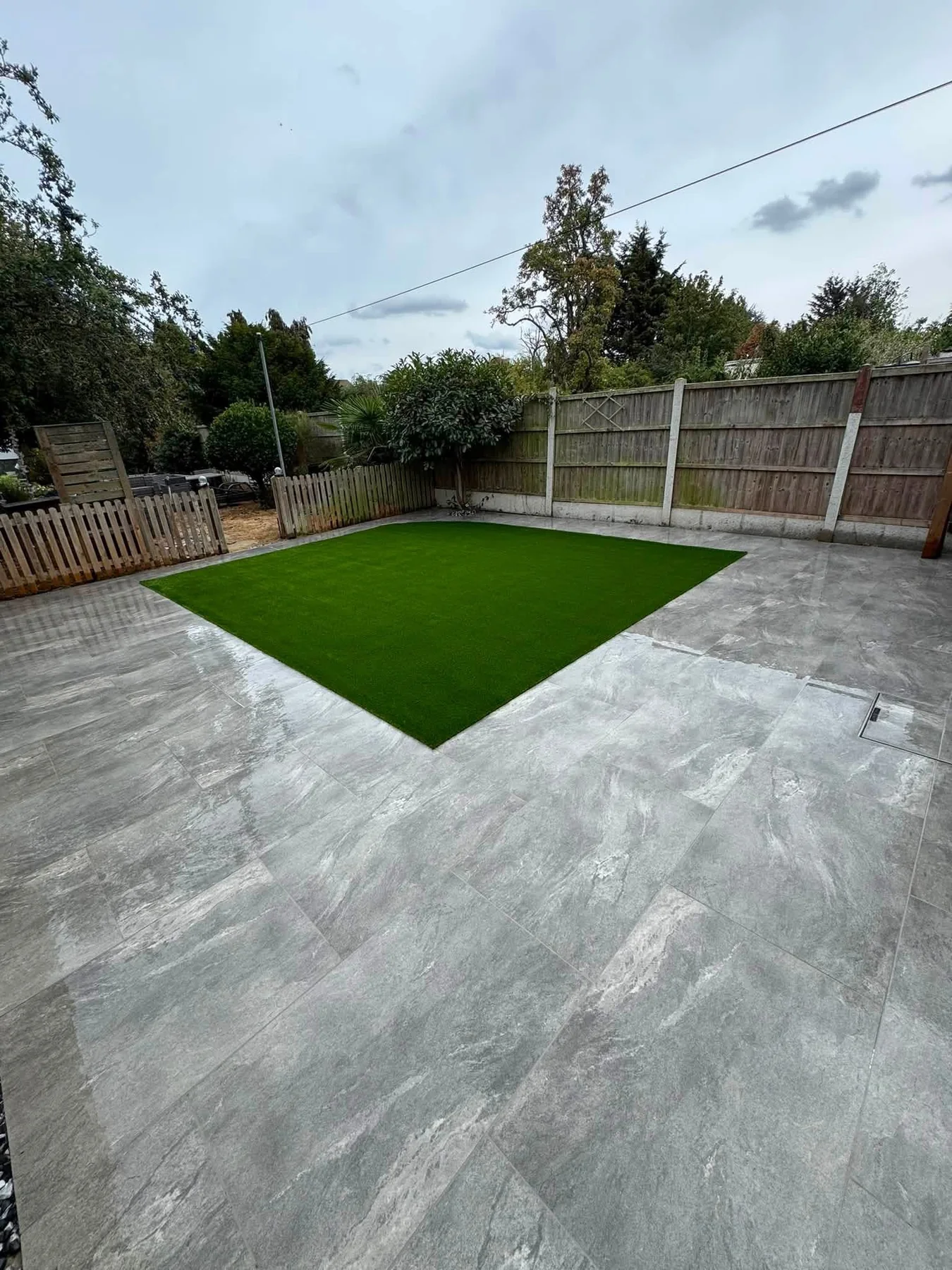 Large paved garden area with lawn
