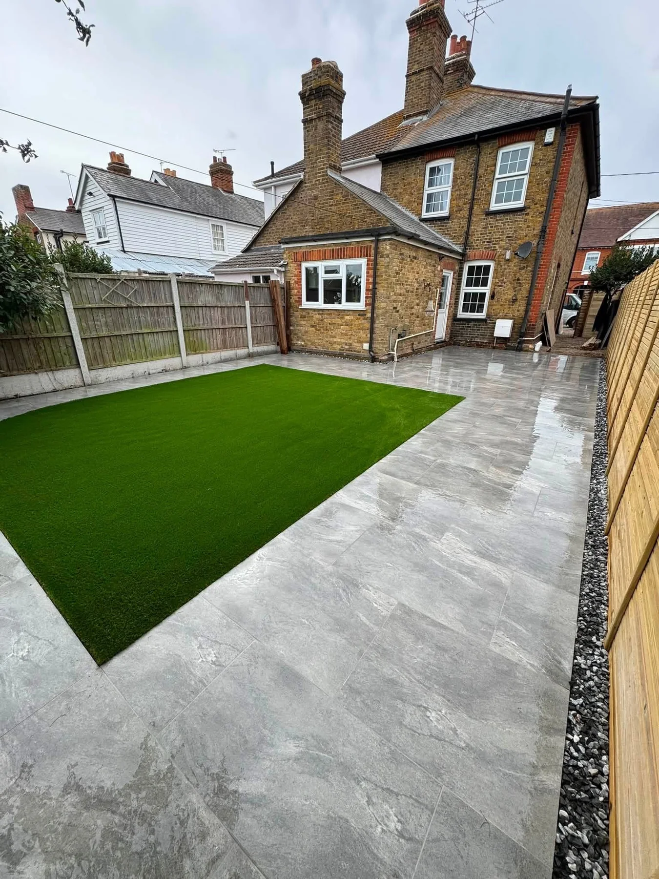 Landscaped garden with lawn and paved area