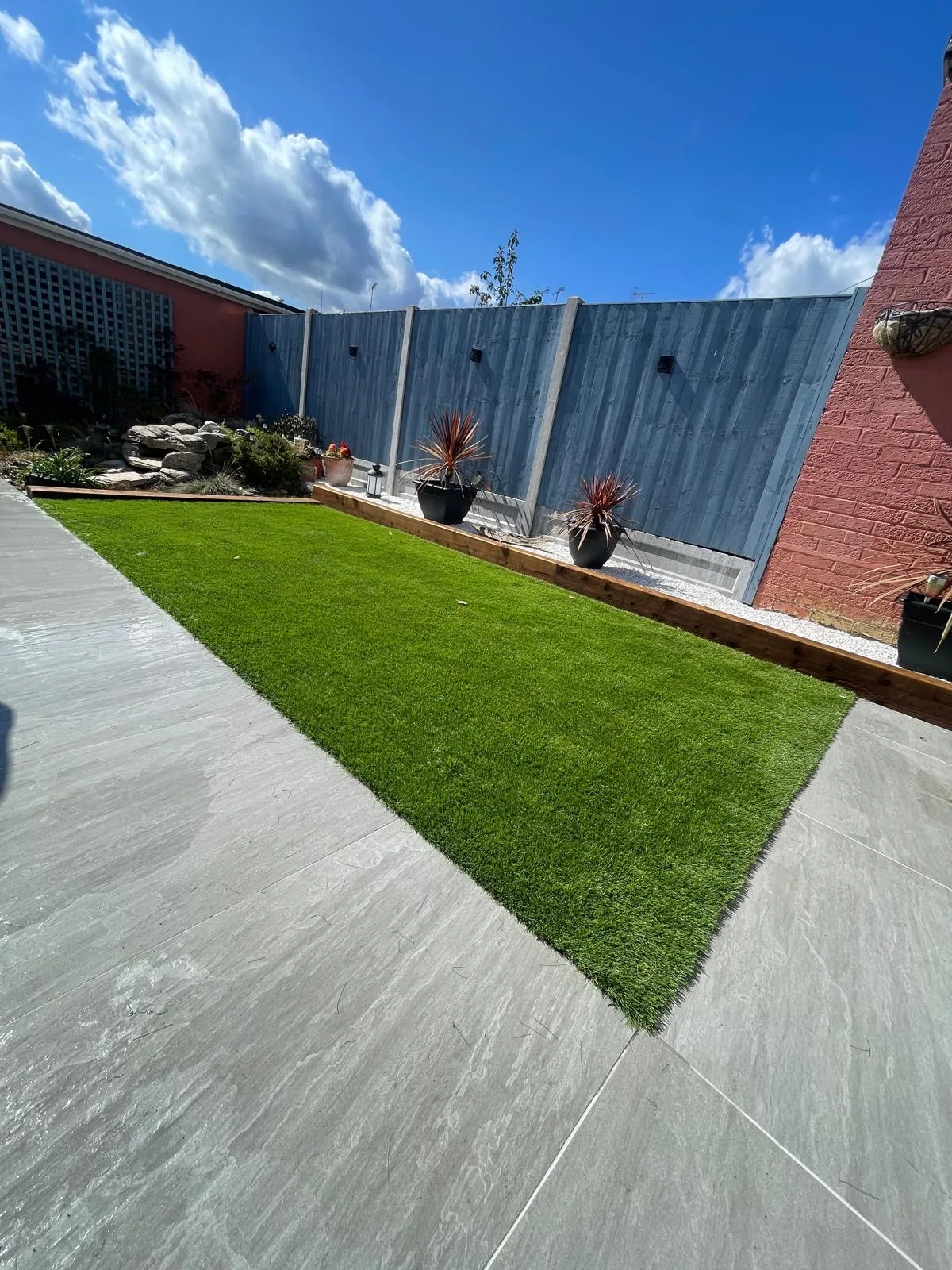 Landscaped garden with lawn and paved area
