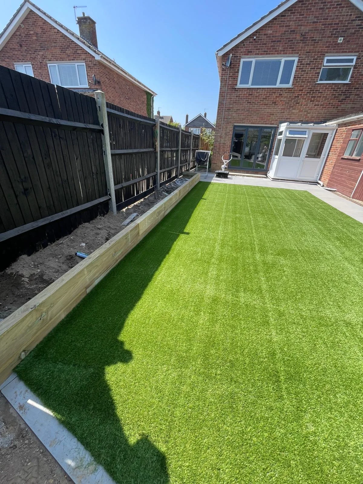 Long rear garden with artificial lawn