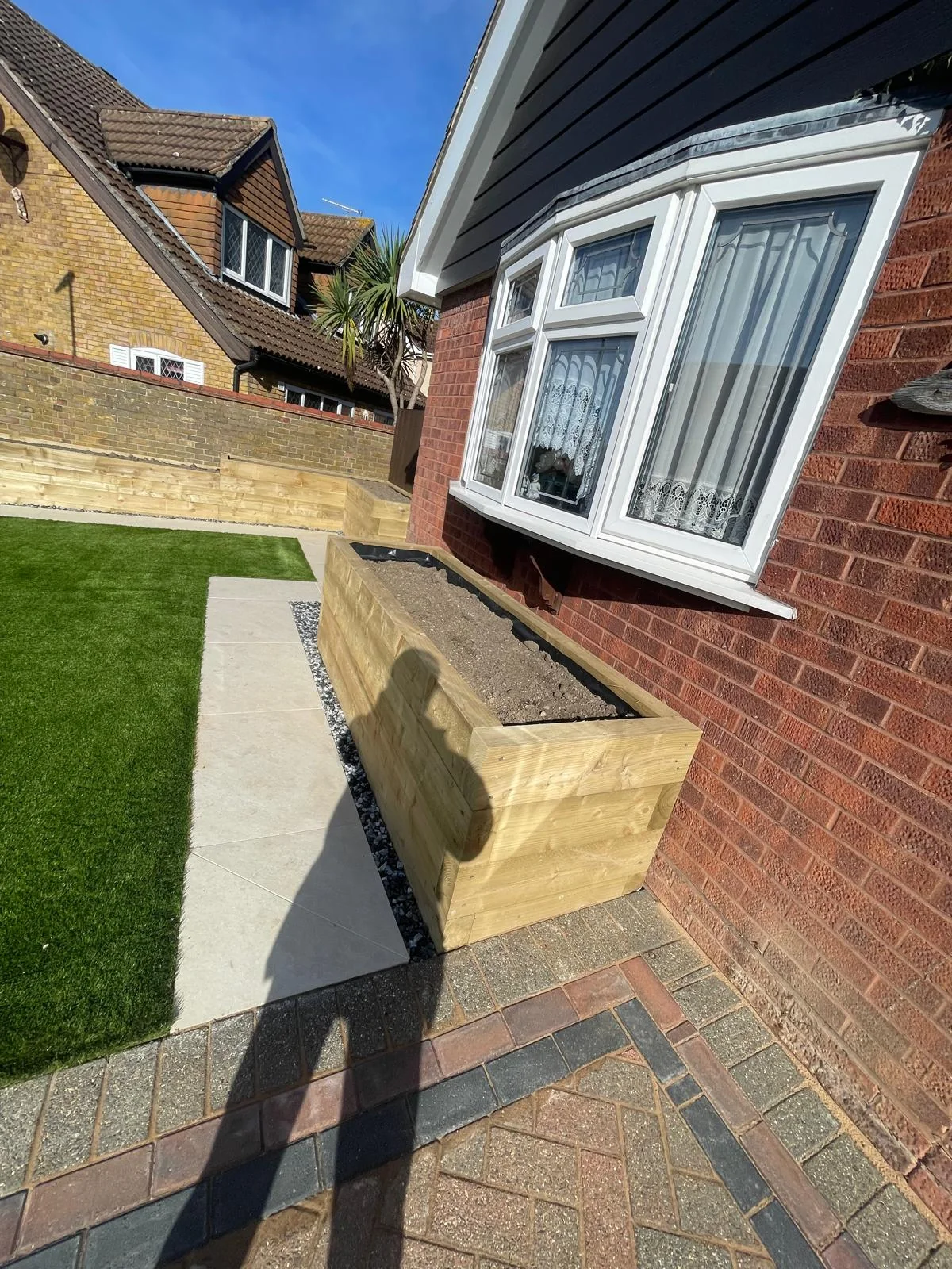 Garden with timber raised planting area and lawn
