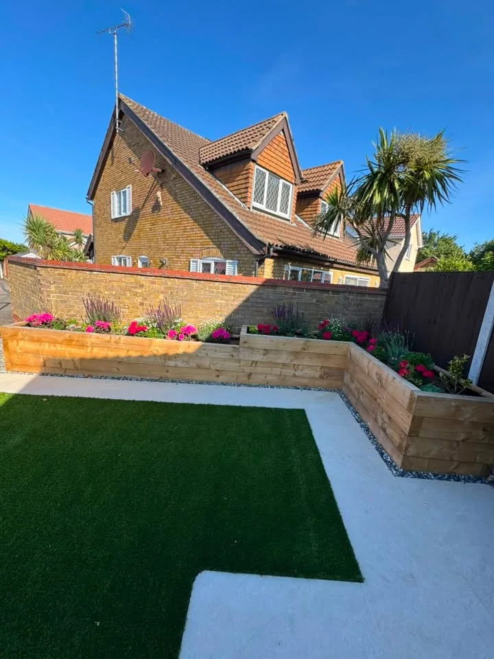 Landscaped garden with lawn and raised timber planting