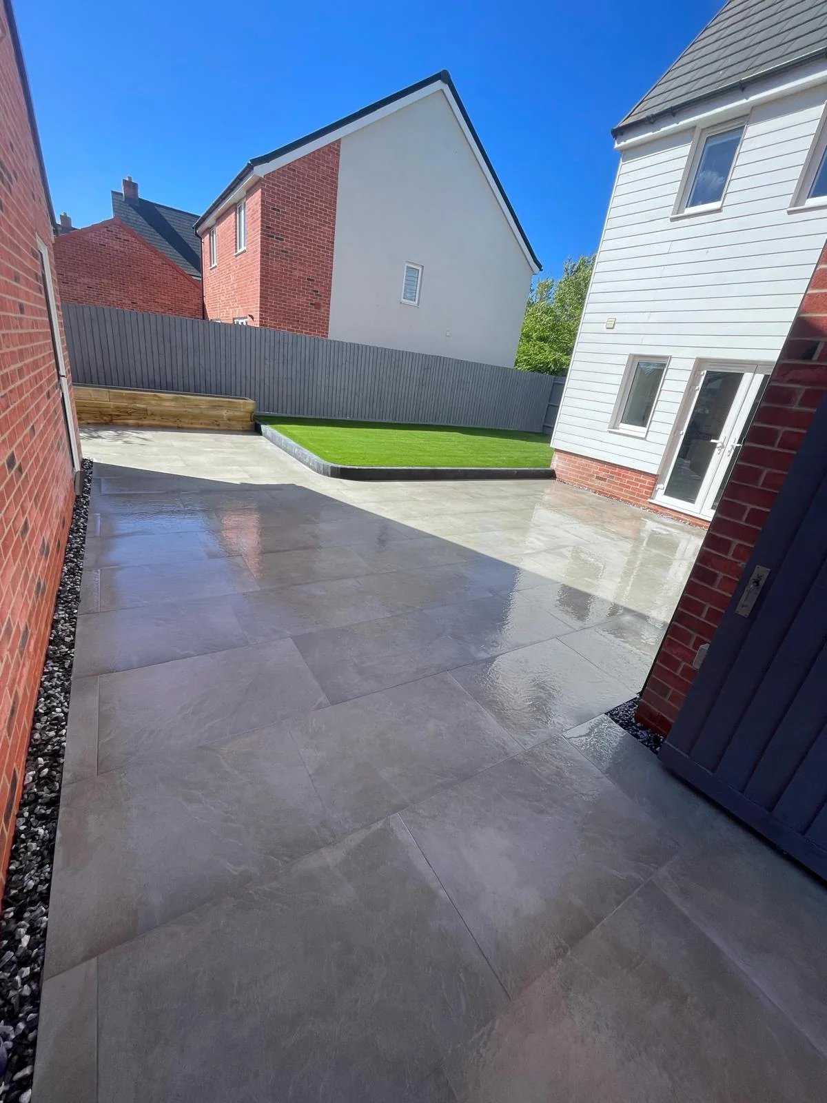 Garden with artificial lawn and paved surround