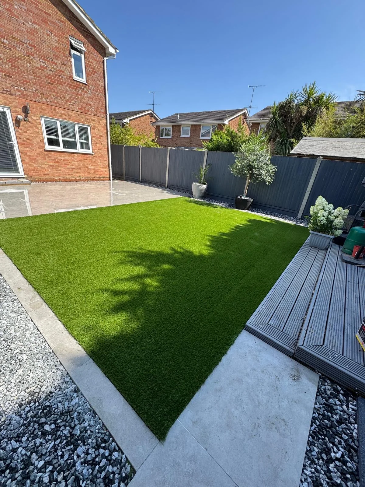 Landscaped garden with lawn and paved area